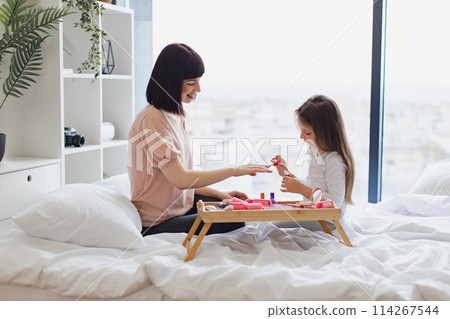 Young mom teaches her daughter to take care of herself. Young mom teaches her daughter to take care of herself. 114267544