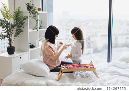 Young mom teaches her daughter to take care of herself. 114267553