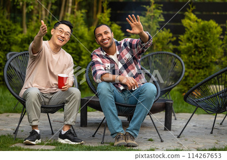 Cheerful friends enjoying cold beer at backyard party Cheerful friends enjoying cold beer at backyard party 114267653