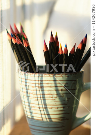Colored pencils in a mug 114267956