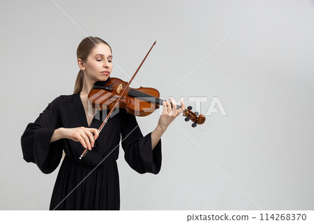 Woman musical artist playing violin 114268370
