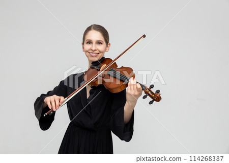 Woman musical artist playing violin 114268387