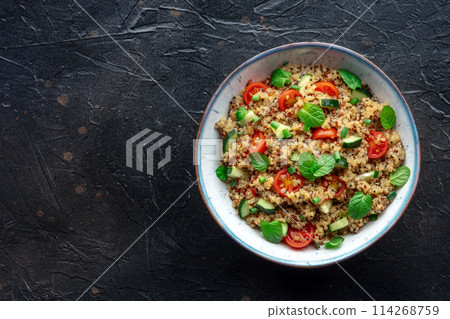 Quinoa tabbouleh salad in a bowl, a healthy dinner with tomatoes and mint Quinoa tabbouleh salad in a bowl, a healthy dinner with tomatoes and mint 114268759