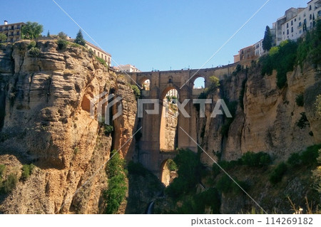 Puente Nuevo arch bridge over the tajo Gorge at Ronda village, Spain. Tourist viewpoint cliff in Ronda province of Malaga, Andalucia Puente Nuevo arch bridge over the tajo Gorge at Ronda village, Spain. Tourist viewpoint cliff in Ronda province of Malaga, Andalucia 114269182