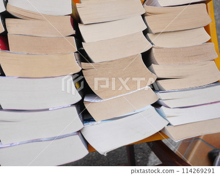 A stack of books with the top one being a hardcover edition of a novel 114269291