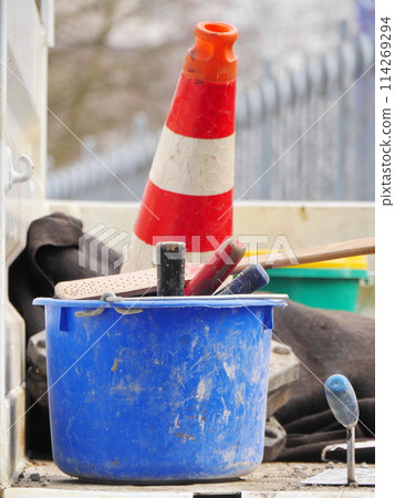 A blue bucket with a red and white cone on top of it A blue bucket with a red and white cone on top of it 114269294