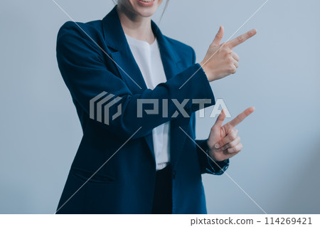 Successful young asian businesswoman in suit ready do business, cross arms confident and smiling. Female entrepreneur determined to win. Happy saleswoman talking to clients, white background 114269421