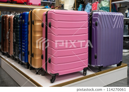 Large selection of colorful suitcases in store. Travel suitcases for sale at the mall. 114270061