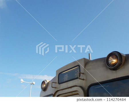 Windmills, blue sky and diesel trains at Oga Station 114270484