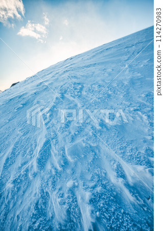 Snowy summit mountain in blizzard 114270983