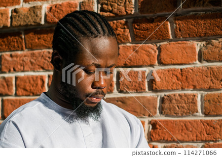 Cheerful male tourist portrait dress in white wear dashiki ethnic smiling at city street or small town background. African American travel model have free time. Millennial generation and gen z people Cheerful male tourist portrait dress in white wear dashiki ethnic smiling at city street or small town background. African American travel model have free time. Millennial generation and gen z people 114271066