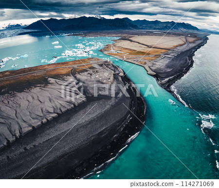 Dramatic moody Jokulsarlon glacier lagoon with iceberg floating and black sand beach in Diamond Beach, Iceland 114271069