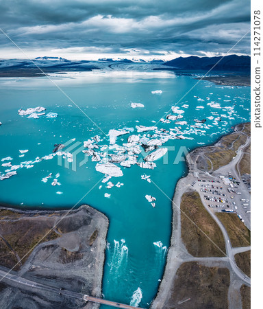 Jokulsarlon glacier lagoon with iceberg floating on gloomy day in Vatnajokull national park, Iceland 114271078