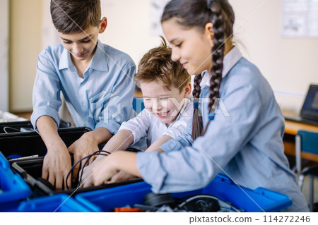 Group of kids choose parts of robotic toys for building robots at school lesson 114272246