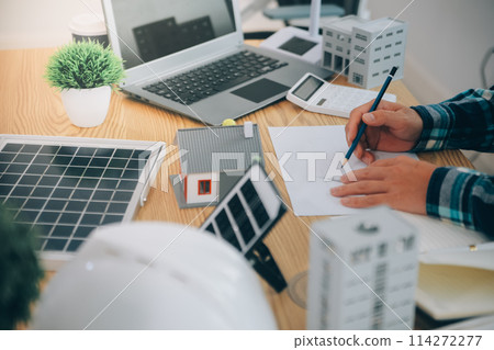 Wind energy engineer designing and developing project for residential district 114272277