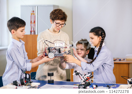 Happy children learn programming using laptops on extracurricular classes 114272278