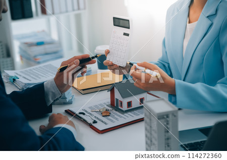 Real estate agent talked about the terms of the home purchase agreement and asked the customer to sign the documents to make the contract legally, Home sales and home insurance concept. 114272360