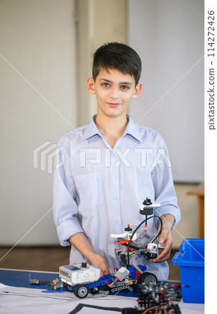 Little boy in robotics school makes robot 114272426