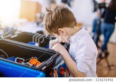 Little boy in robotics school makes robot Little boy in robotics school makes robot 114272442