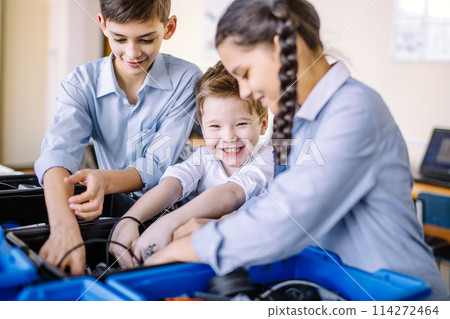 Group of kids choose parts of robotic toys for building robots at school lesson 114272464