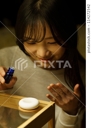 A woman is soothed by aroma before going to bed 114272542