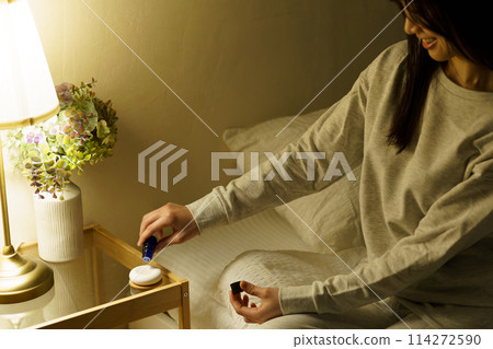 A woman is soothed by aroma before going to bed A woman is soothed by aroma before going to bed 114272590