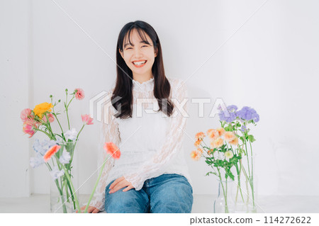 A woman surrounded by flowers A woman surrounded by flowers 114272622