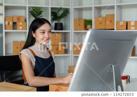 Woman asian in an online store check the customer address and package information on box. Online shopping concept Woman asian in an online store check the customer address and package information on box. Online shopping concept 114272653