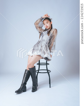 Fashion portrait of a woman wearing a fashionable dress Fashion portrait of a woman wearing a fashionable dress 114272915