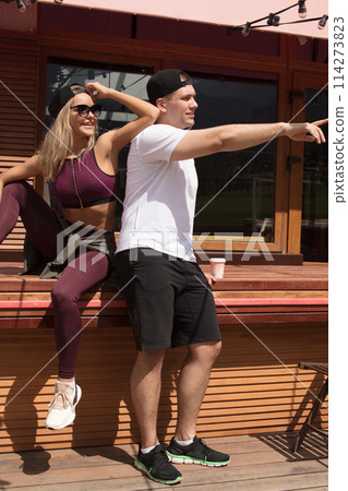 Man and woman dating in mountain outdoor cafe after sports workout 114273823