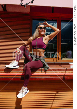 Woman resting at summer cafe after a hard morning training. 114273960
