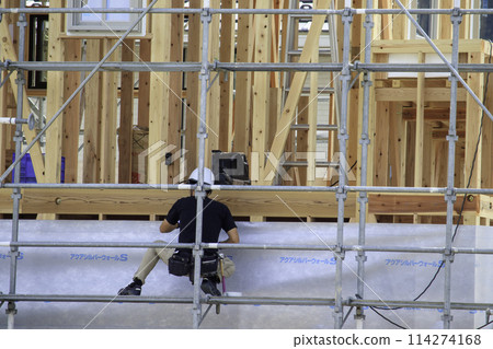 Construction work underway on a wooden house Construction work underway on a wooden house 114274168