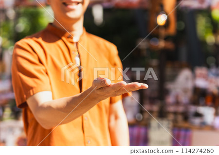 Happy man with open hand inviting to enter with smiling. 114274260
