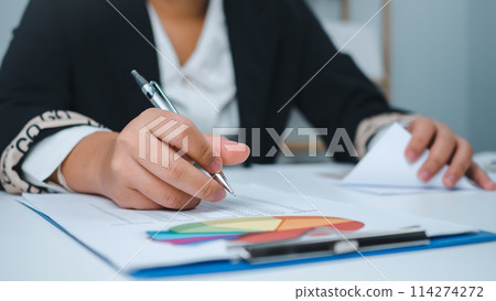 Business woman people use computers and paper documents to analyze business and manage corporate information. Business analysis with charts, indicators, and KPIs to improve organizational performance. 114274272