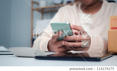 Business women holding smartphone with a checked box on Excellent Smiley Face and Rating for a satisfaction survey, Evaluation of product service quality by customers, Positive customer feedback. Business women holding smartphone with a checked box on Excellent Smiley Face and Rating for a satisfaction survey, Evaluation of product service quality by customers, Positive customer feedback. 114274275