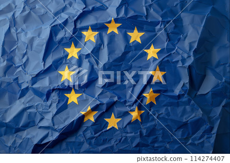Blue paper with crumpled texture and gold stars resembling the flag of the European Union. 114274407