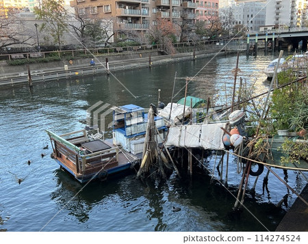 A small boat anchored on the river A small boat anchored on the river 114274524