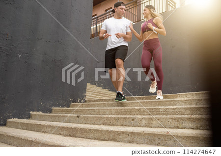 Couple running on stairs in morning, jogging in urban area with starecases. Couple running on stairs in morning, jogging in urban area with starecases. 114274647