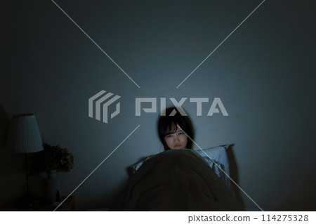 Young woman spending her time in bed Young woman spending her time in bed 114275328