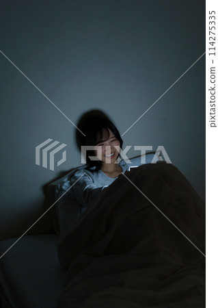 Young woman spending her time in bed 114275335