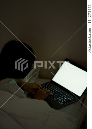 Young woman spending her time in bed 114275351