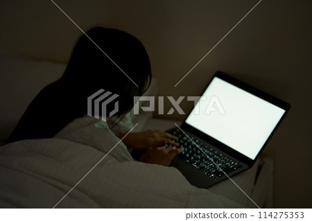 Young woman spending her time in bed 114275353