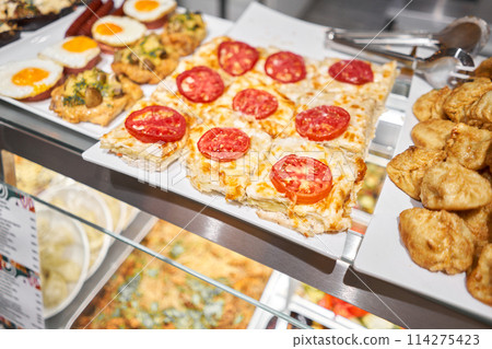 Various hot dishes . Glass Showcase in a buffet or self-service restaurant. 114275423