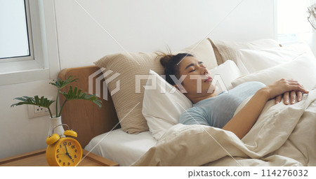 Asian women sleep wake up in white cozy bedroom happy time morning sunrise. Beautiful chinese use hand stop time alarm clock. Happy person lifestyle wake up in morning wellbeing relax sleepy napping Asian women sleep wake up in white cozy bedroom happy time morning sunrise. Beautiful chinese use hand stop time alarm clock. Happy person lifestyle wake up in morning wellbeing relax sleepy napping 114276032