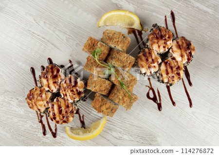 Set of various sushi rolls on a white wooden background. Japanese food. Set of various sushi rolls on a white wooden background. Japanese food. 114276872