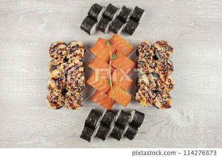 Set of various sushi rolls on a white wooden background close-up. Set of various sushi rolls on a white wooden background close-up. 114276873