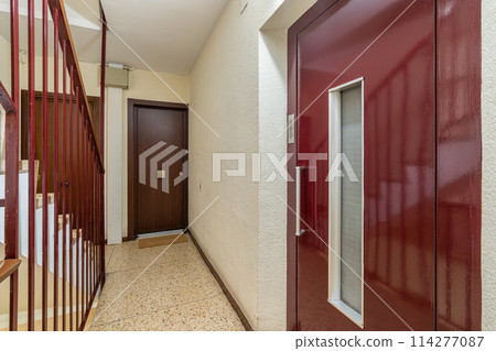Traditional Staircase in a Residential Building with Red Accents Traditional Staircase in a Residential Building with Red Accents 114277087