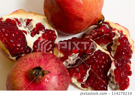 Purified pomegranate fruit on a white background Purified pomegranate fruit on a white background 114278219