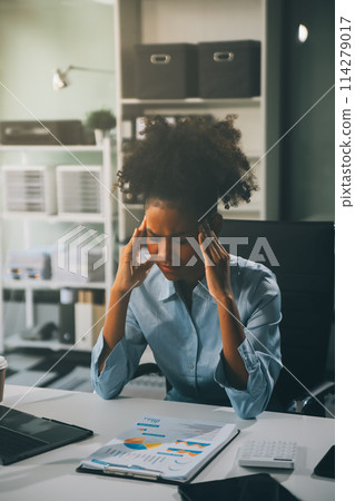 business woman sitting at work stressed , out working hard Feeling stressed out and dizzy from your job business woman sitting at work stressed , out working hard Feeling stressed out and dizzy from your job 114279017