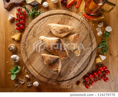 Rustic homemade calzones 114279770